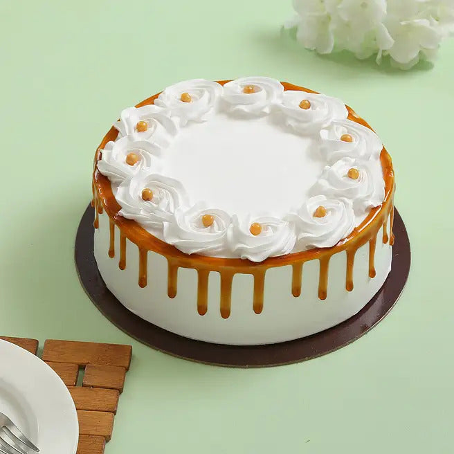 Caramel Crown butterscotch cake with caramel drip, cream rosettes and butterscotch pearls