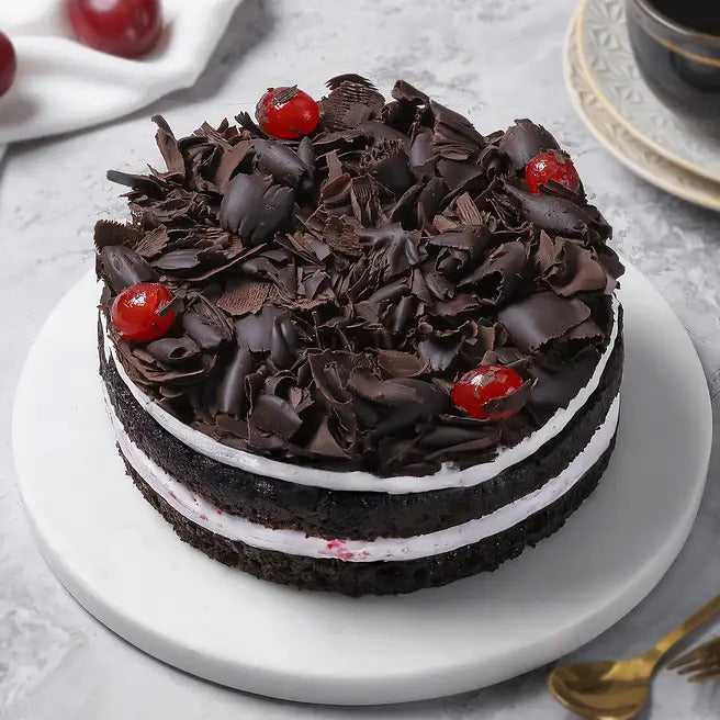 Cherry Noir black forest cake with chocolate shavings, cream layers and cherry topping