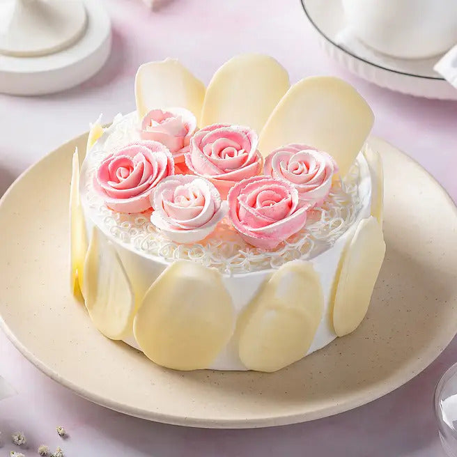 Rosette Frost white forest cake with pink cream roses and white chocolate petals