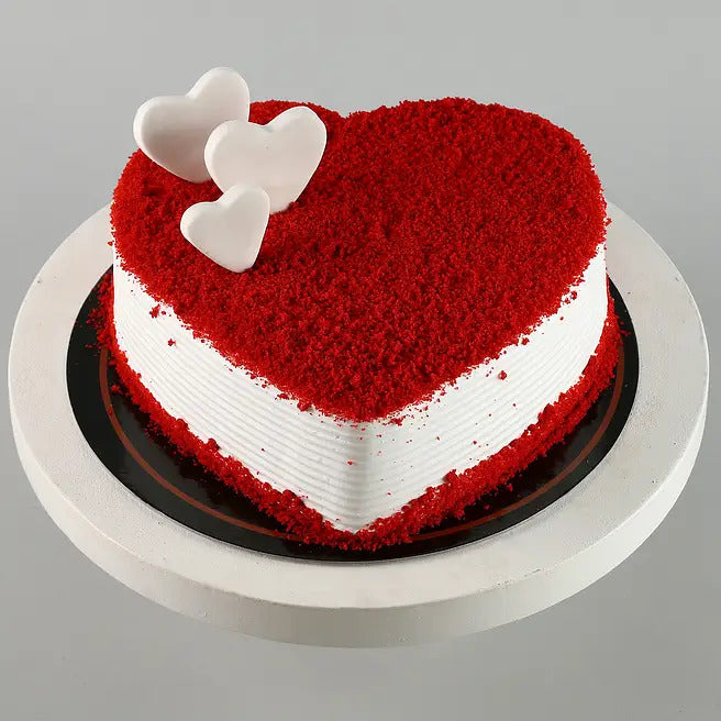 Cupid Velvet heart shaped red velvet cake with white chocolate hearts and cream frosting