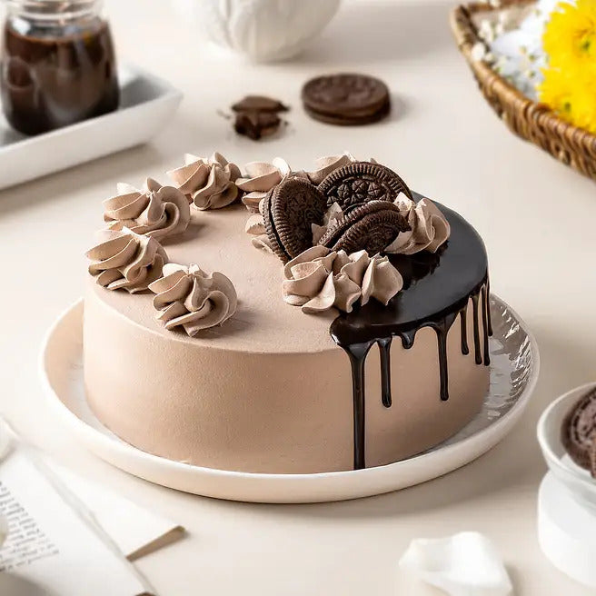 Fudge Orbit chocolate Oreo cake with cookie toppings, cream swirls and ganache drip
