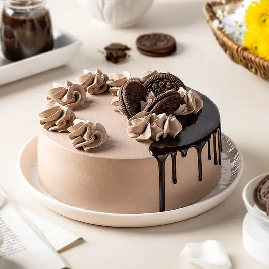 Fudge Orbit chocolate Oreo cake with cookie toppings, cream swirls and ganache drip