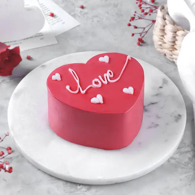 Love Velvet red heart shaped chocolate cake with love message and mini heart decorations