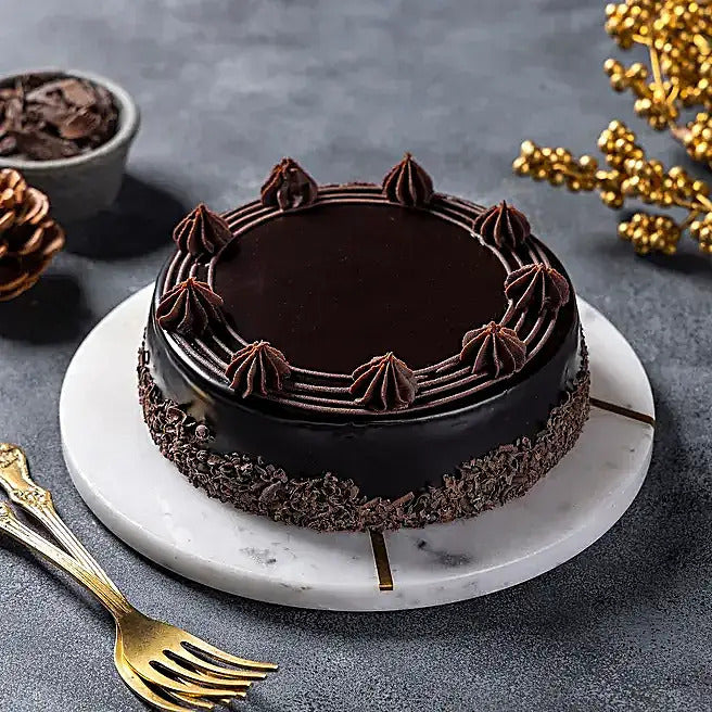Midnight Truffle dark chocolate cake with glossy glaze, cream swirls and chocolate flakes