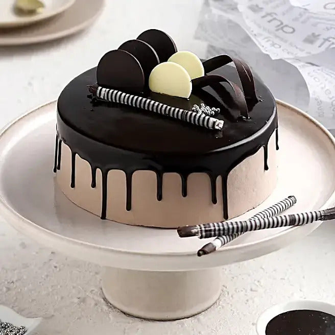Obsidian Charm chocolate drip cake with glossy glaze, chocolate discs and wafer sticks