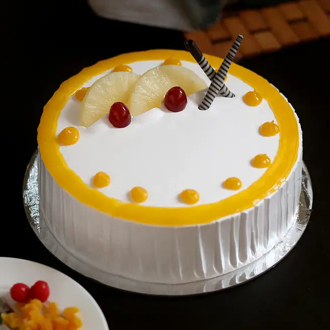 Pineapple Glow cream cake with pineapple slices, cherries and yellow glaze topping