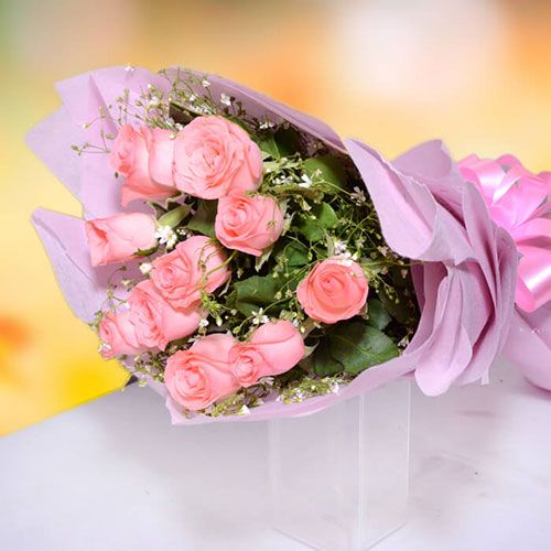 Rosy Whisper bouquet of 10 fresh pink roses with white fillers and pink wrapping
