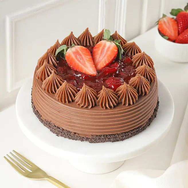 Strawberry Ganache chocolate cake with fresh strawberry topping and chocolate cream swirls