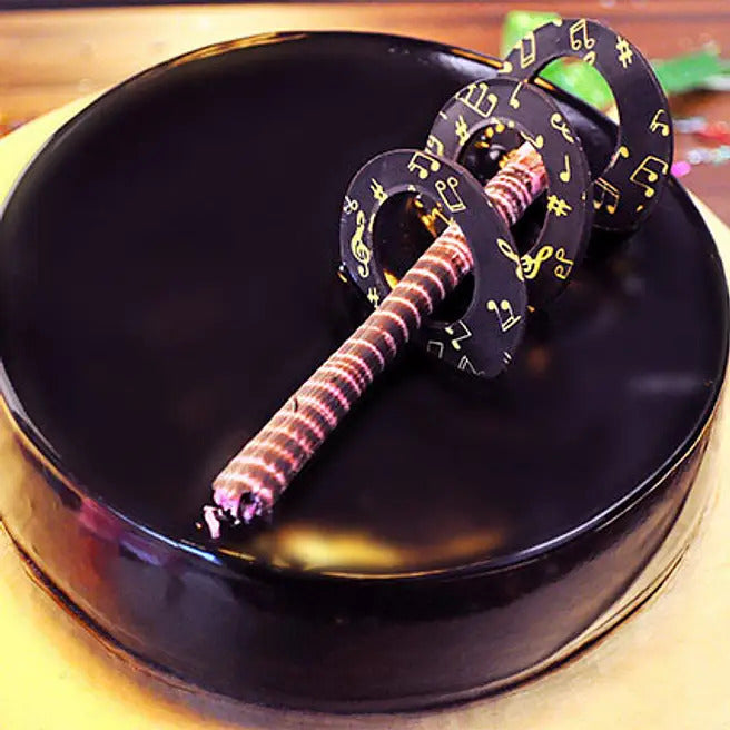 Symphony Glaze chocolate truffle cake with glossy dark chocolate finish and musical garnish