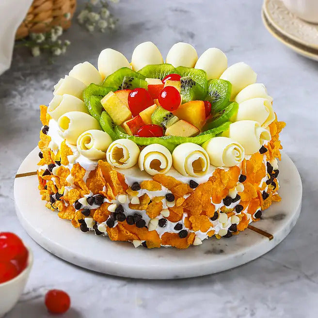 Tropical Carnival fresh fruit cake with kiwi, apple, pineapple, cherries and white chocolate curls