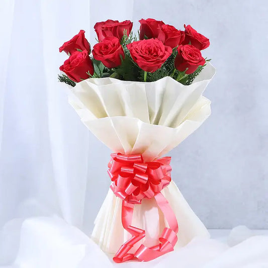 Velvet Tribute bouquet of 10 fresh red roses in ivory wrapping with decorative red ribbon