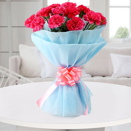 Pink carnations bouquet in blue wrapping elegant flower gift