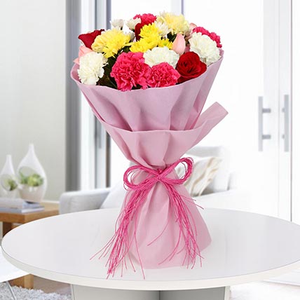 Mixed flowers bouquet with roses and carnations in pink wrapping