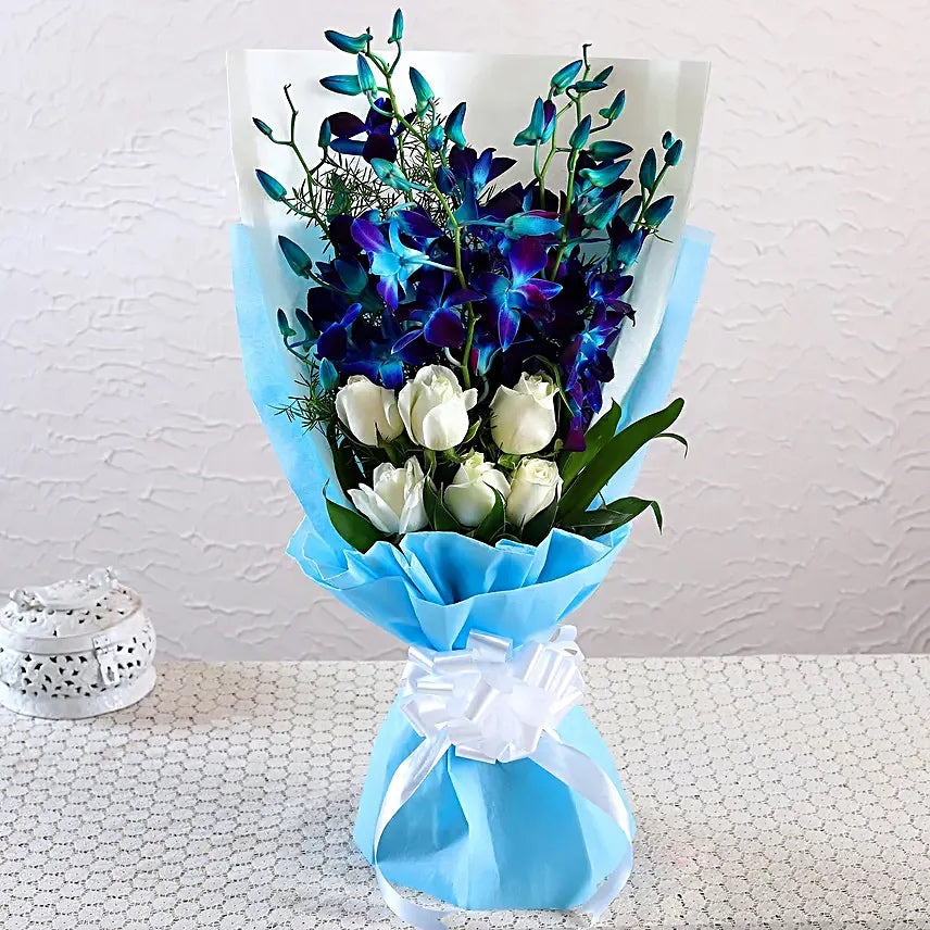Blue orchid and white rose bouquet in premium blue wrapping with white ribbon