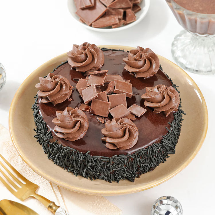 Chocolate truffle cake with ganache, cream swirls and choco flakes for celebration delivery