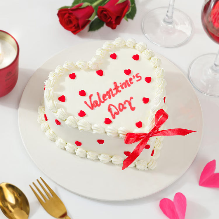 Heart-shaped Valentine cream cake with red hearts for romantic cake delivery India
