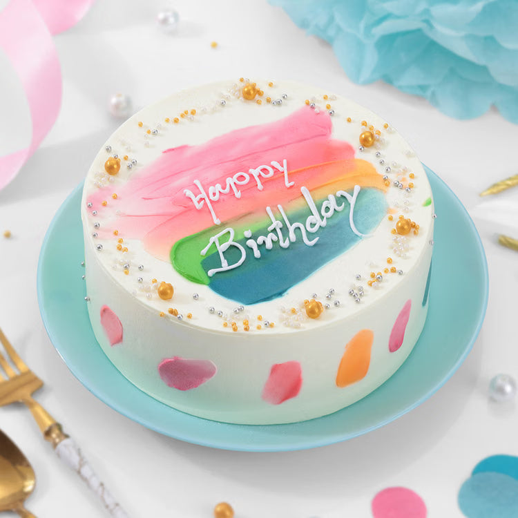 Rainbow birthday cake with Happy Birthday message and pearl decoration for kids and family celebration