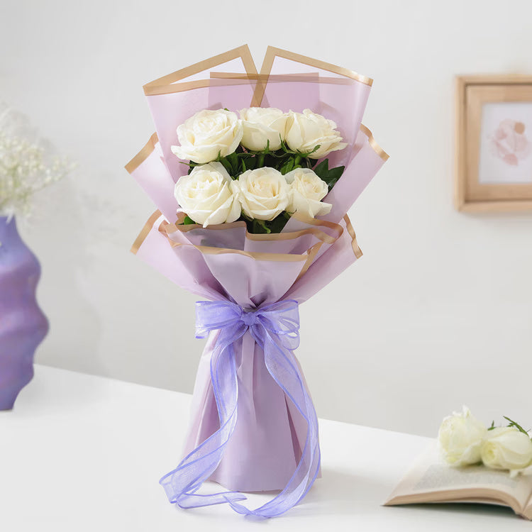 10 fresh red roses bouquet in red and cream wrapping with ribbon