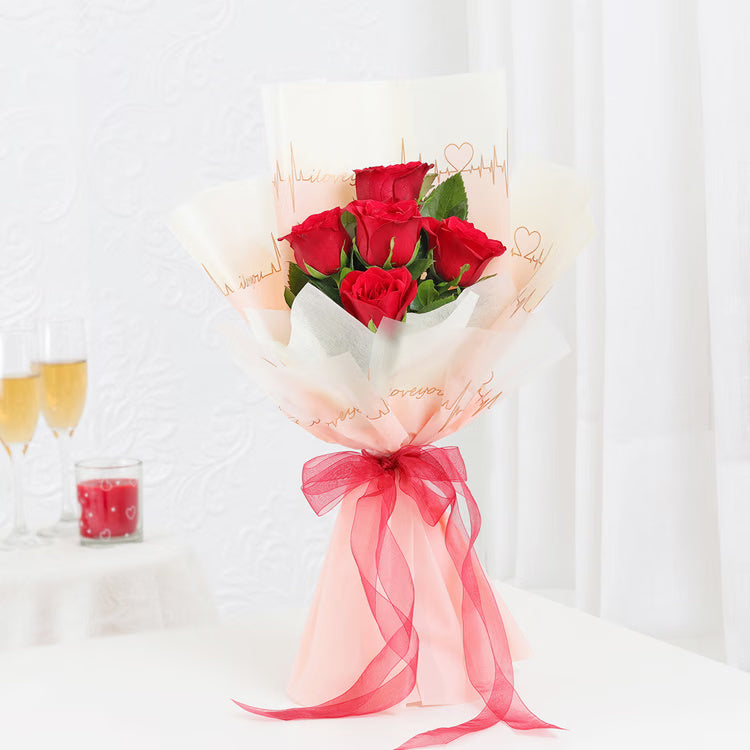 6 fresh red roses bouquet in peach love-note wrapping with red ribbon