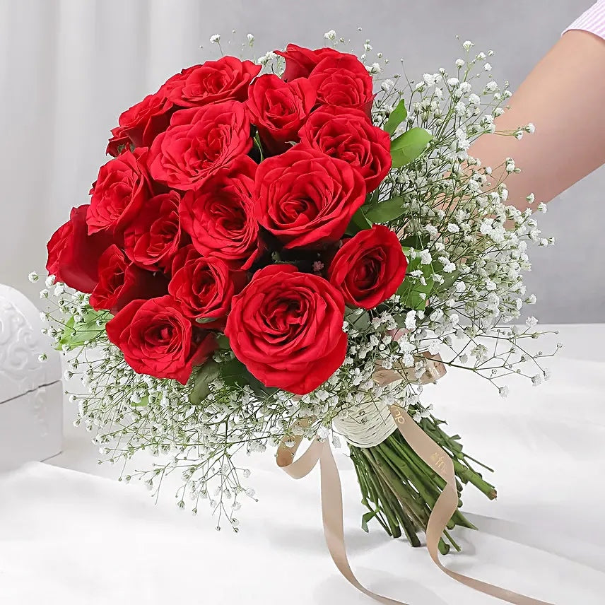 Fresh red rose bouquet with baby’s breath and ribbon for romantic gifting