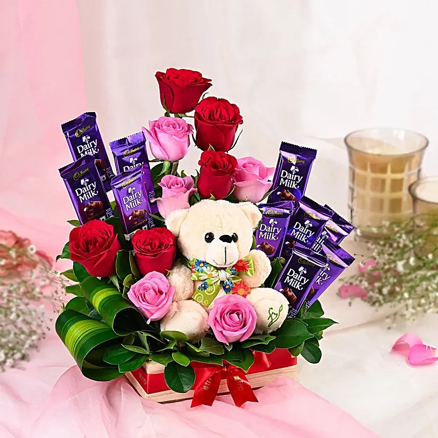 Teddy bear with Dairy Milk chocolates and red pink roses basket for birthday and anniversary gift