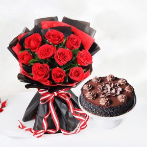 Red roses bouquet in black wrapping with chocolate truffle cake for romantic gift delivery