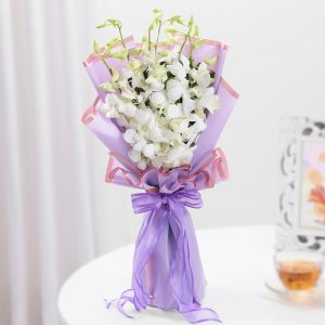 White orchid bouquet in lavender wrapping for same day flowe