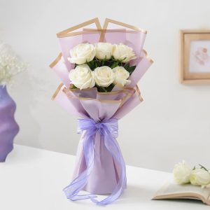 Fresh white roses bouquet in lavender wrapping for birthday anniversary and elegant gift