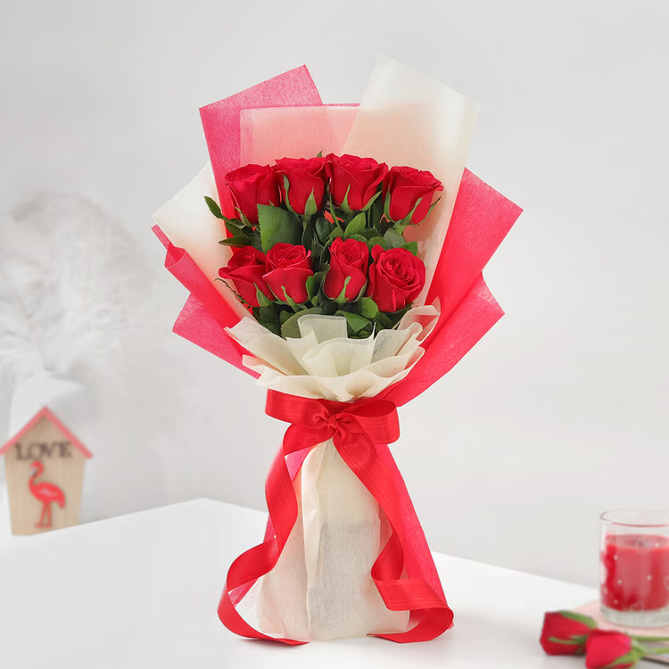 10 fresh red roses bouquet in red and cream wrapping with ribbon