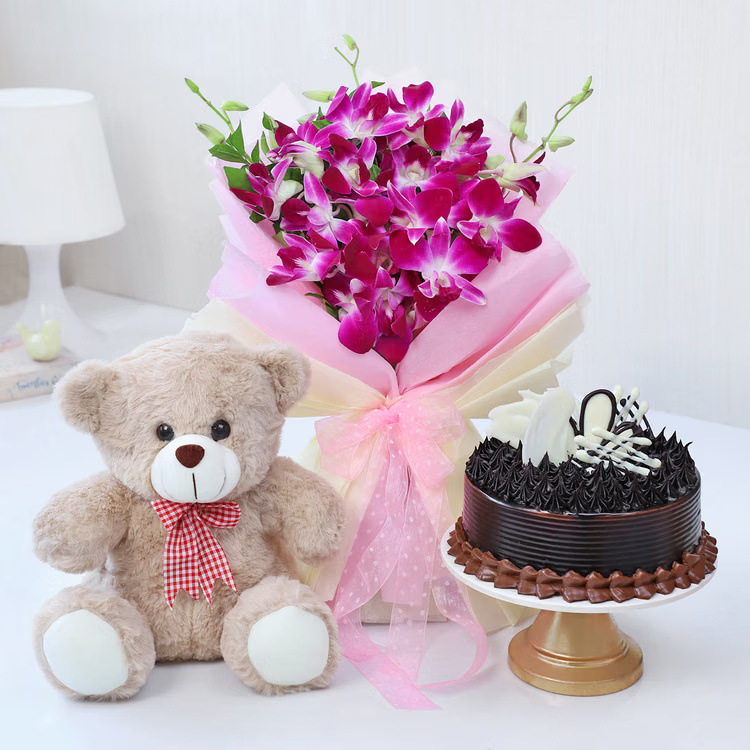 A premium orchid bouquet with teddy bear and chocolate cake, perfect for sweet and romantic surprises. Purple orchid bouquet with teddy bear and chocolate cake for birthday anniversary and romantic gift