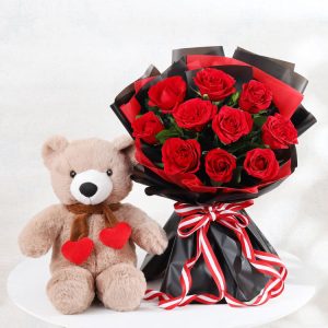 Cute teddy bear with fresh red roses bouquet for birthday anniversary and romantic gift